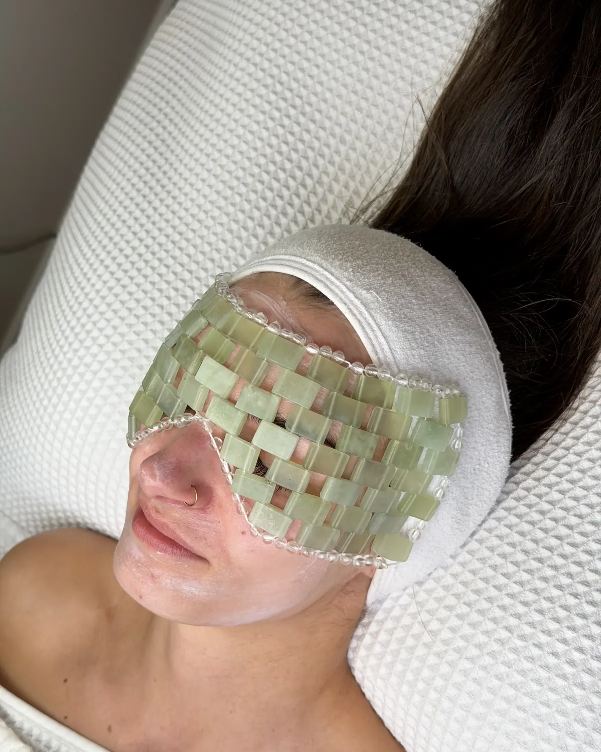 A cooling jade eye mask during the signature facial